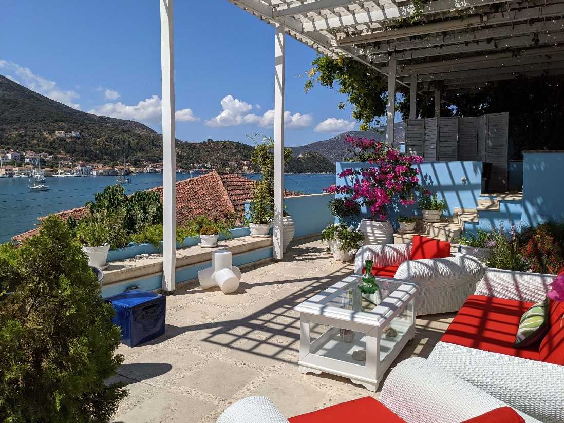 Perantzada Art Hotel terrace — white pergola, bougainvillea and Vathy bay beyond