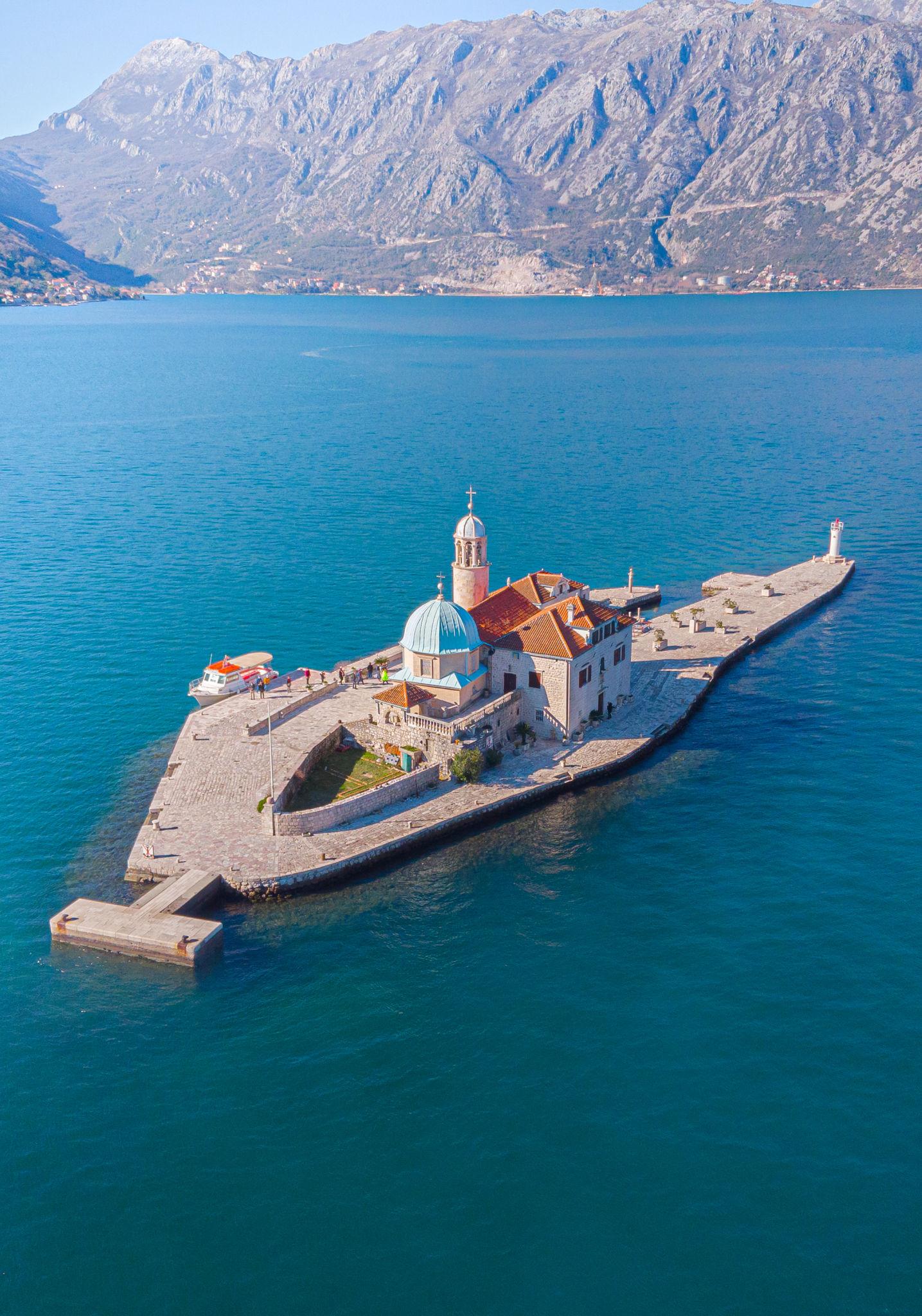 Our Lady of the Rocks — the man-made island in the Bay of Kotor with blue dome and karst mountains