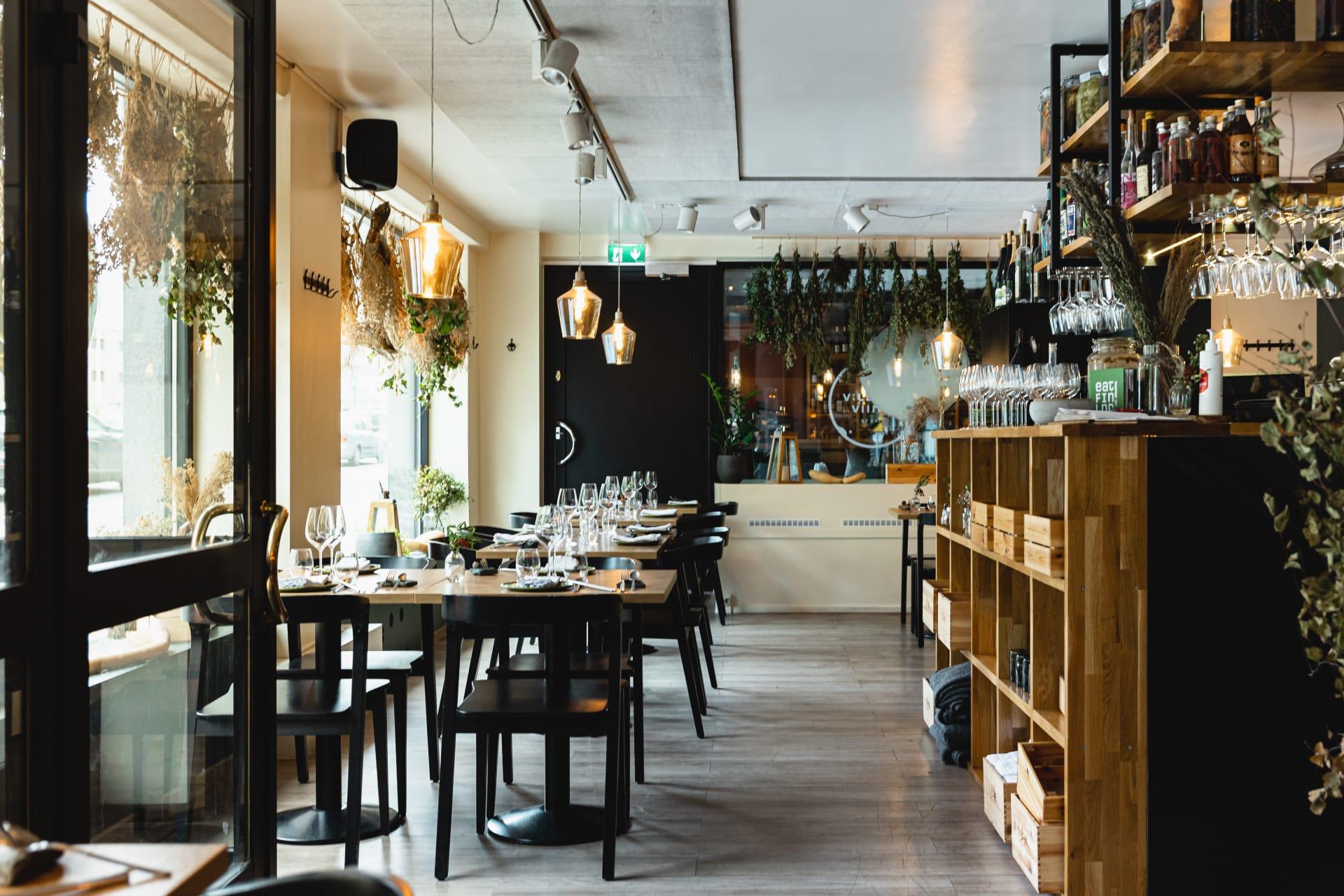 Villit ja Viinit wine bar — dried herbs, pendant lights and wooden shelving