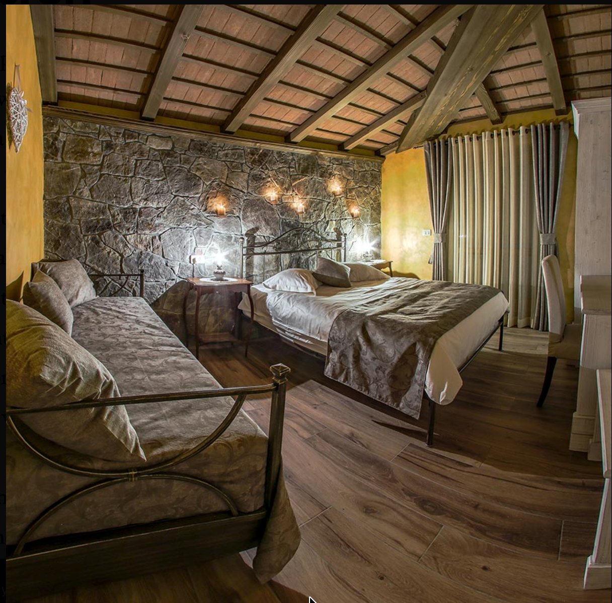 Stone-walled bedroom interior at Theodosius Forest Village